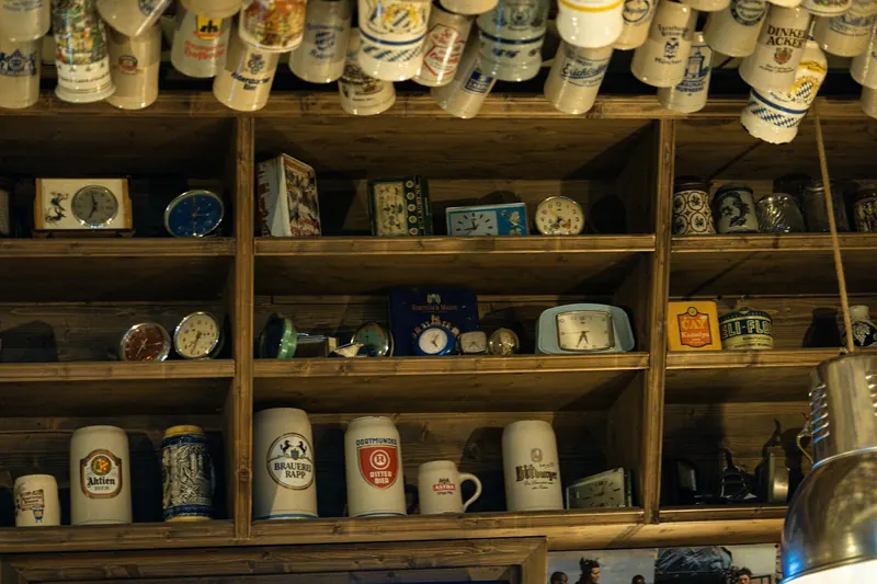 Wooden shelves full of beer steins and collectables