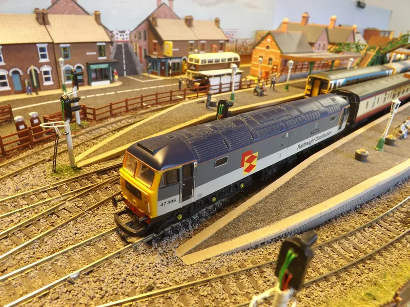 Colourful model railway with a diesel locomotive and small houses