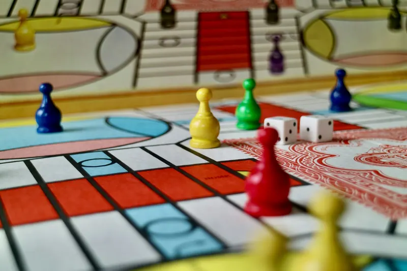 Board game with colourful pieces and dice