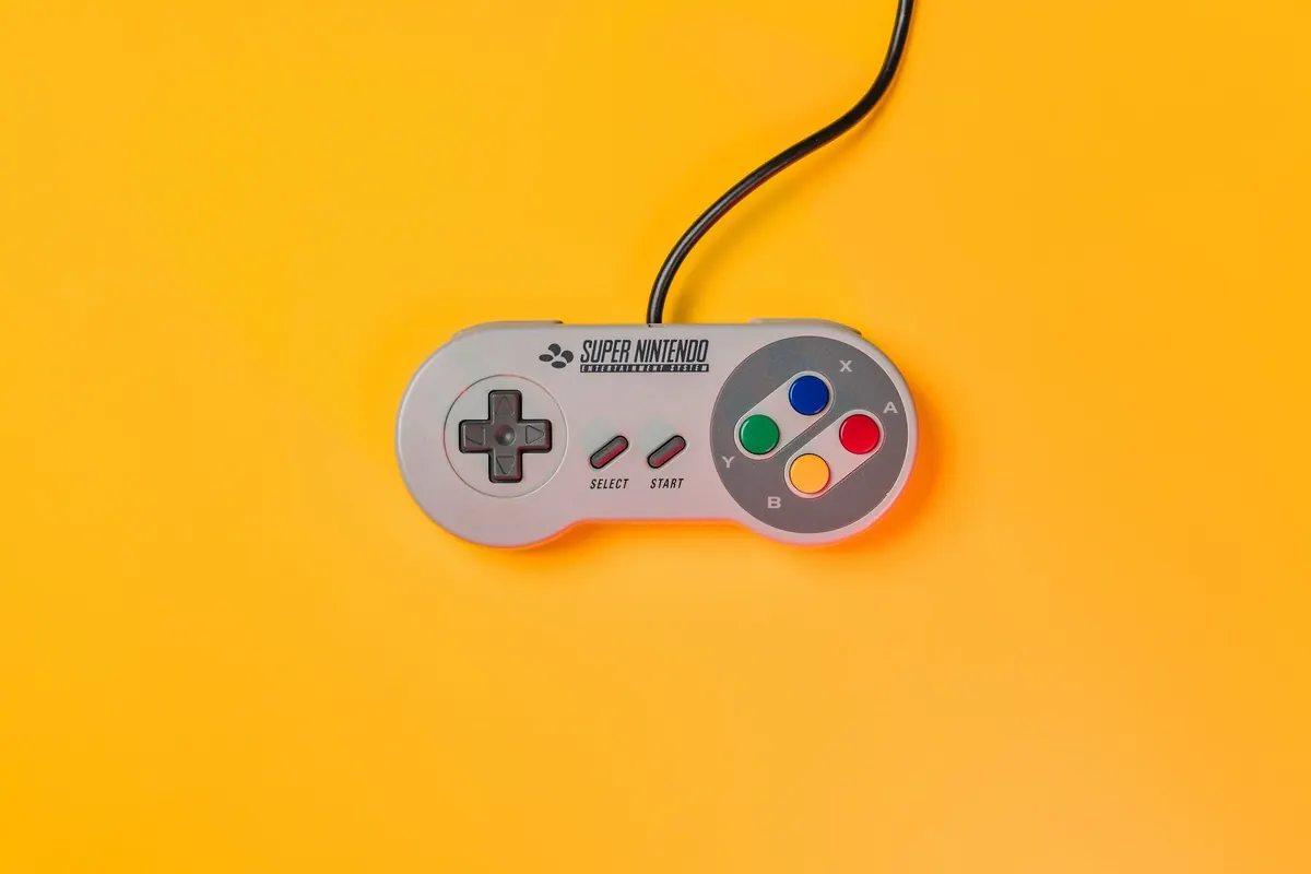Gamepad with a cable on a yellow background