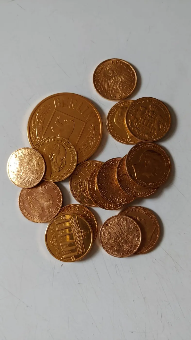 Imperial German gold coins on a white surface